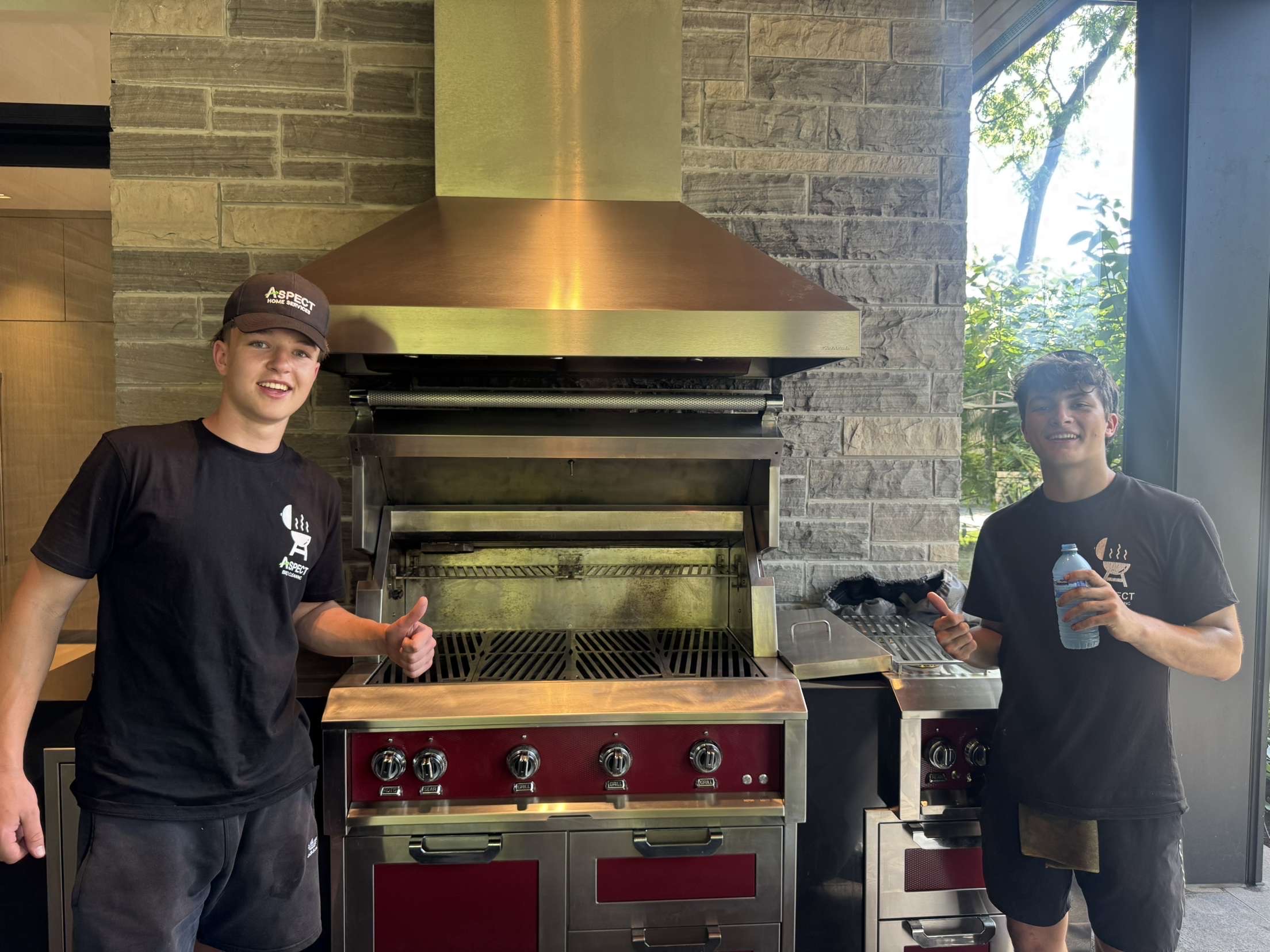 Aspect Muskoka technicians at a cottage outdoor kitchen