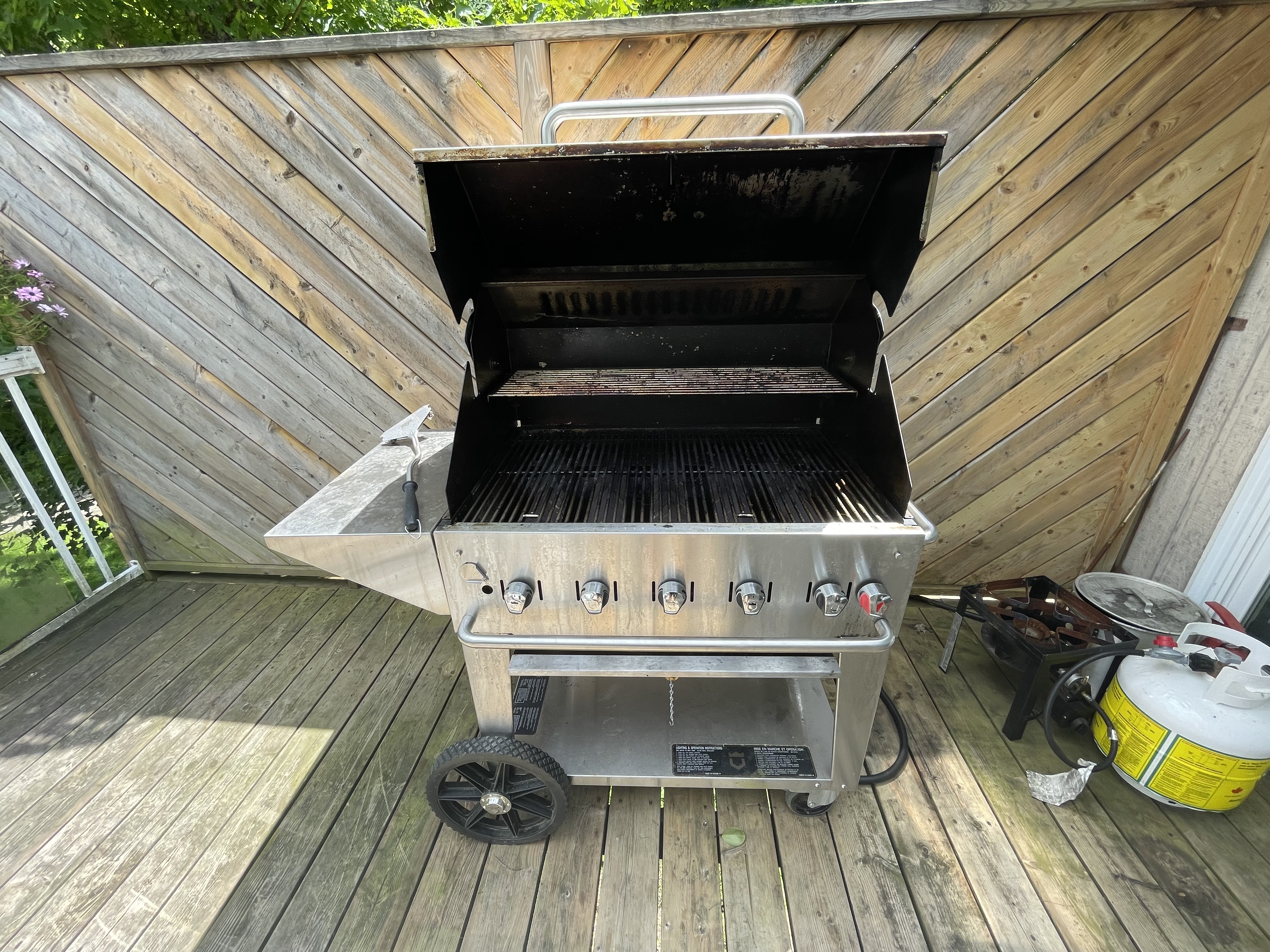 Large stainless 5-burner BBQ open and cleaned