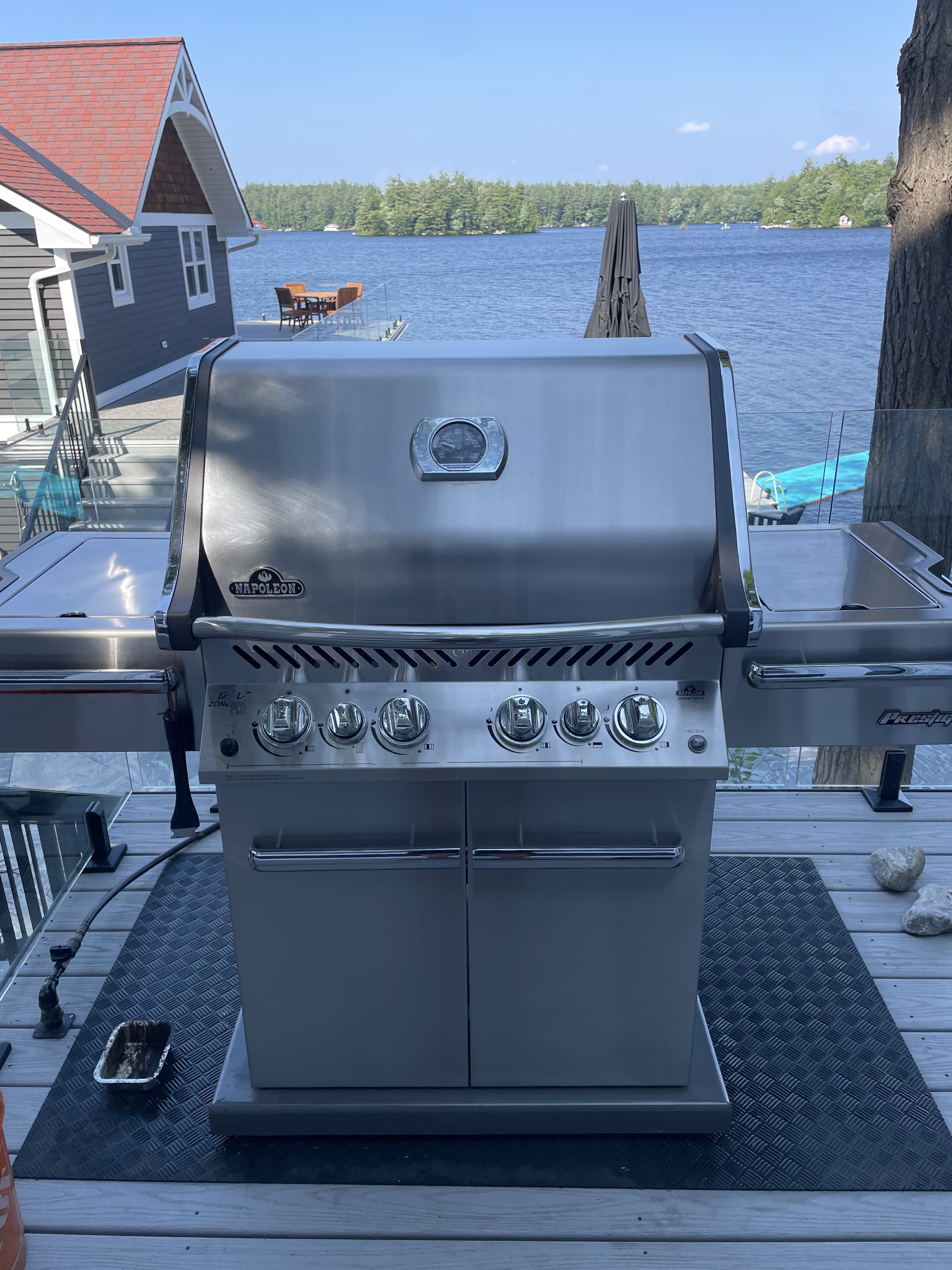 Napoleon BBQ freshly cleaned on a deck overlooking the lake