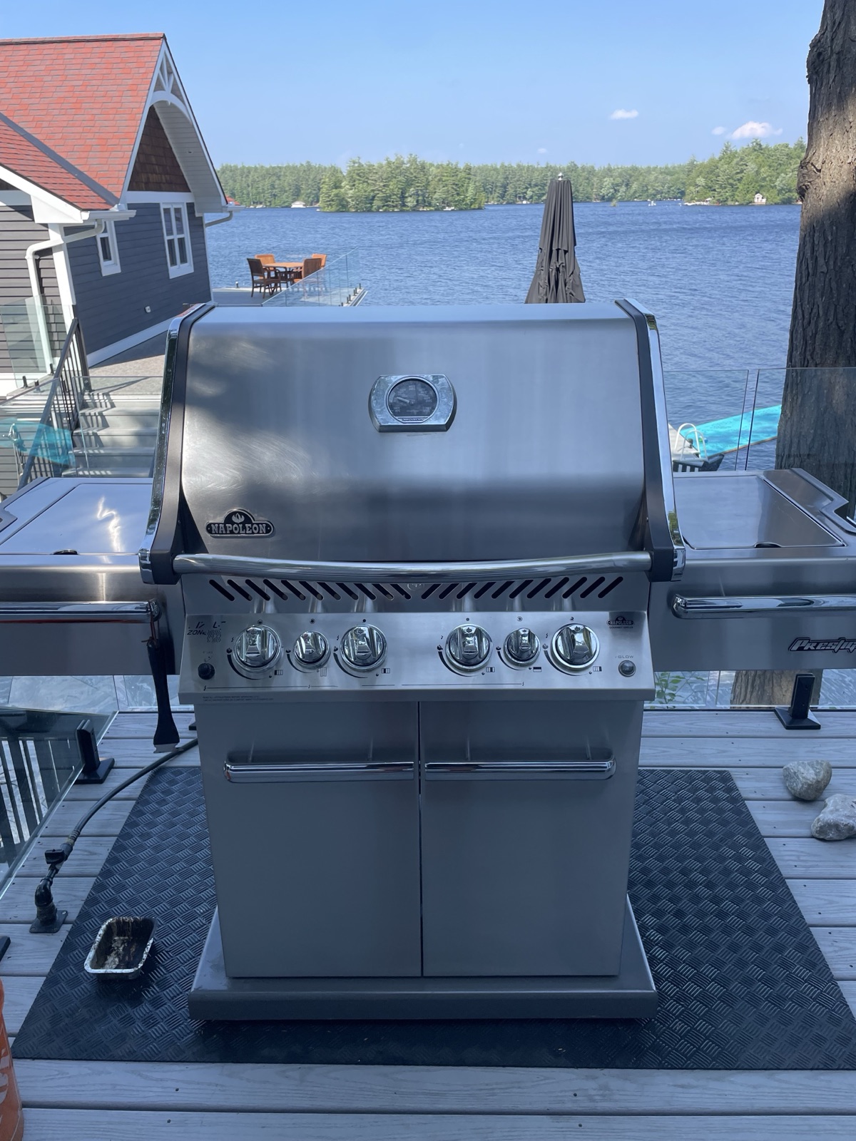 Napoleon BBQ freshly cleaned on a deck overlooking the lake