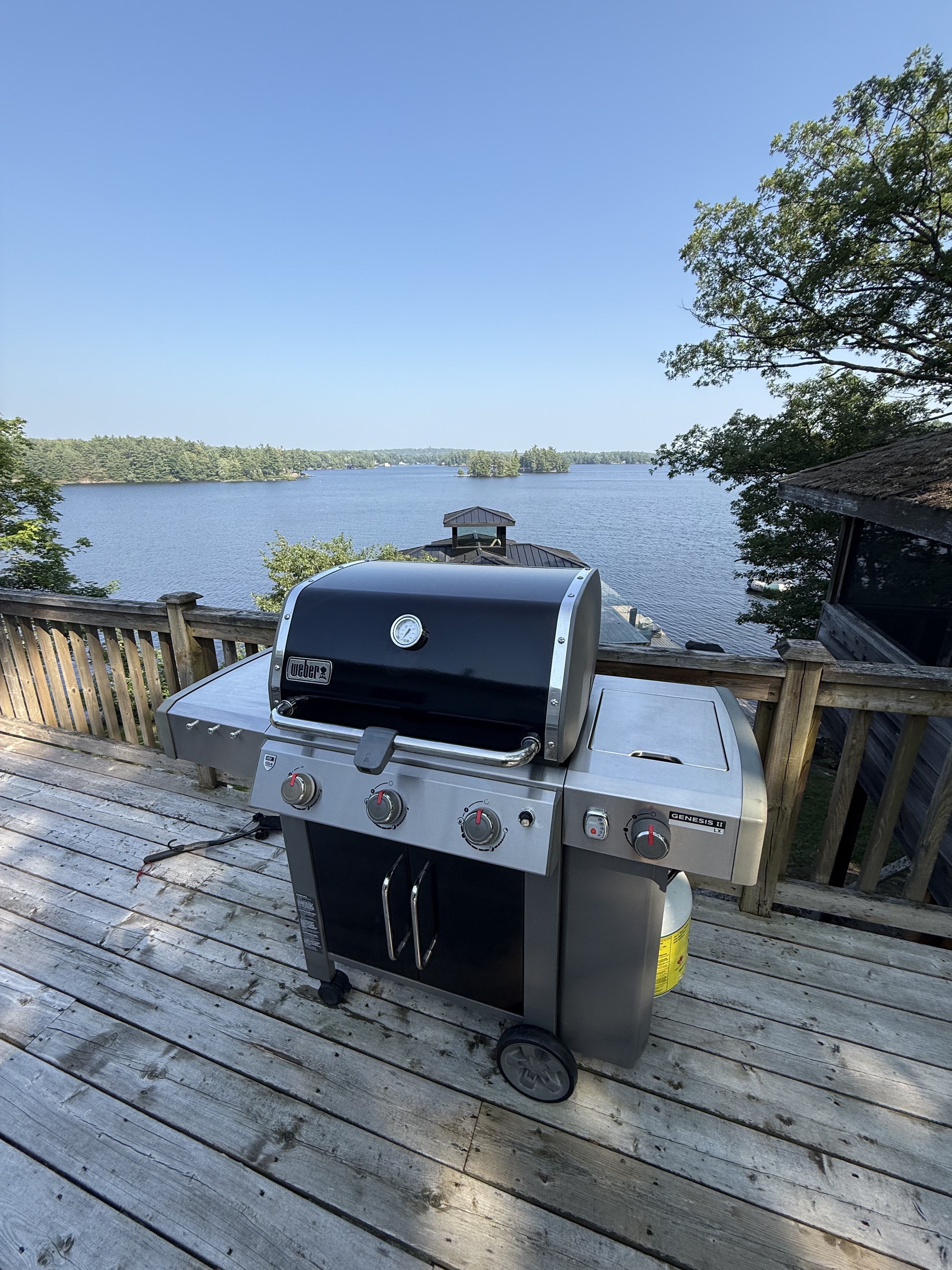 Weber BBQ cleaned on a cottage dock at golden hour
