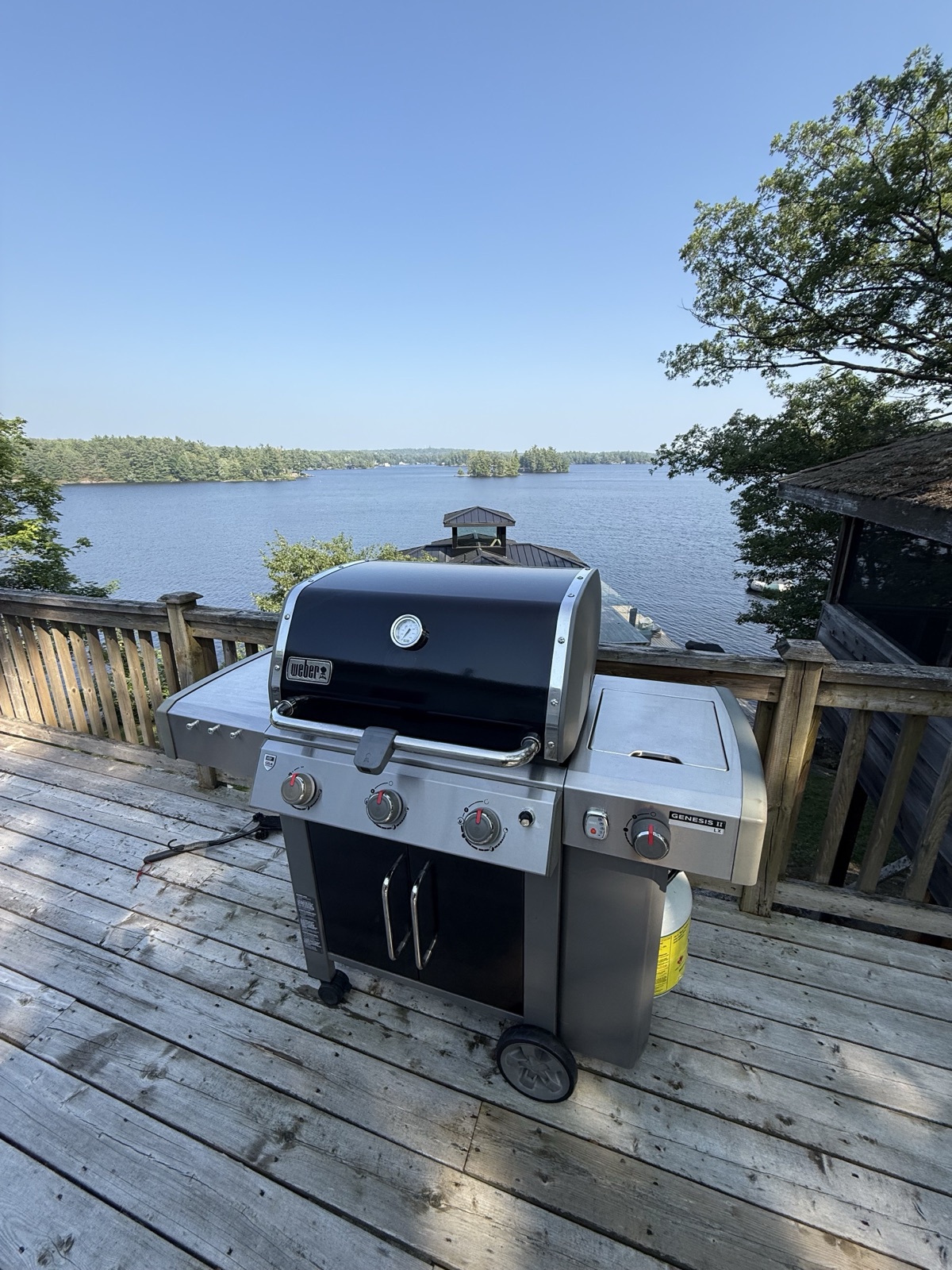Weber BBQ cleaned on a cottage dock with lake view